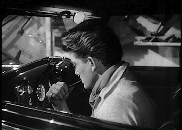 Orphée listens to the number stations of the Underworld on the car radio of Death's Rolls-Royce for poetic inspiration